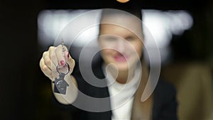 Young Happy Smiling Business Woman Or Real Estate Agent Showing Keys From New House. Isolated Over Background. Focus On