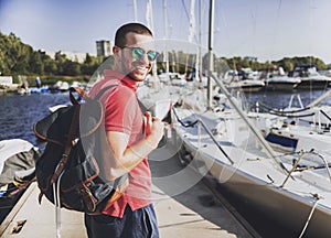 Young Happy Smiling Man in Glasses in Yacht Club.