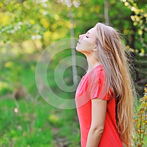 Young happy smiling woman doing deep breath photo