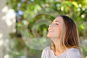 Young happy smiling woman doing deep breath exercises