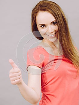 Woman making thumb up gesture