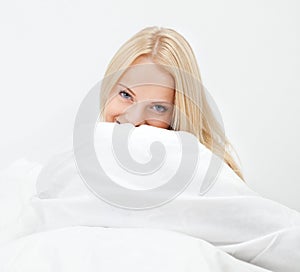 Young happy smiling woman waking up