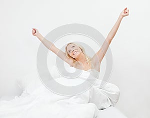 Young happy smiling woman waking up
