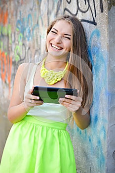 Young happy smiling woman working on pda tablet pc