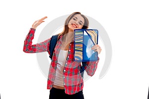 Young happy student girl with folders for notebooks posing isolated on white background in studio