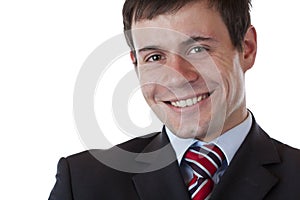 Young happy successful businessman looks at camera