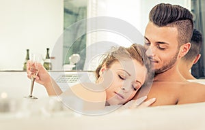 Young happy successful couple enjoying an hot bath