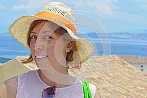 Young happy tanned girl portrait with sea in background