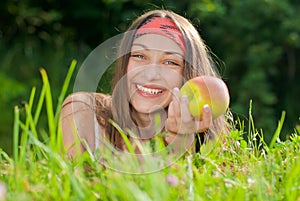 Young happy teenage girl with apple