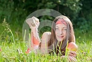 Young happy teenage girl & apple outdoors