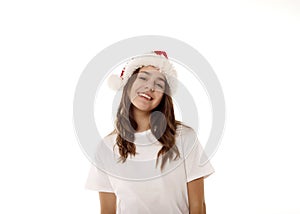 Young happy teenager girl wearing Santa Claus red hat over white background. Christmas and New Year celebration concept