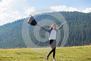 Young happy tourist woman with backpack on top of mountains enjoy freedom