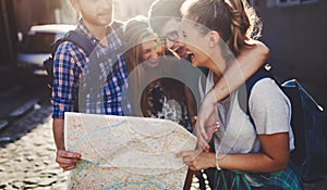 Young happy tourists sightseeing in city