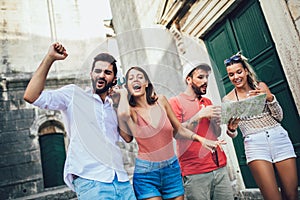 Young happy tourists sightseeing in city.