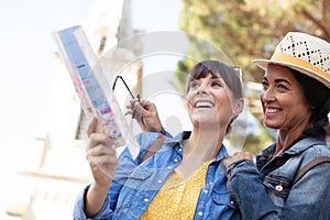 young happy tourists sightseeing in city