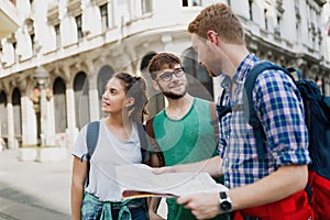 Young happy tourists sightseeing in city