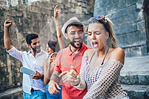 Young happy tourists sightseeing in city.