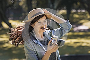 Young happy traveler exploring surrounds with film camera