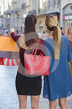 Young happy and wealthy women shopping