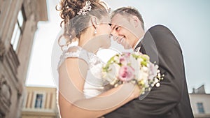 Young happy wedding couple bride meets groom on a wedding day. Happy newlyweds on terrace with gorgeous view.