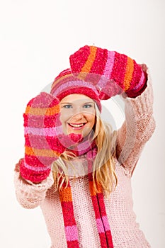 Young happy winter woman in pink gloves