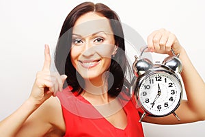 Young happy woman with alarmclock