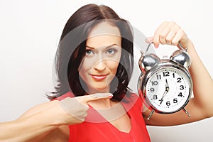 Young happy woman with alarmclock