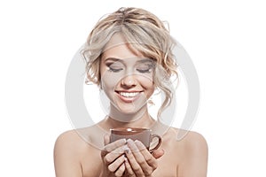 Young happy woman with an aromatic coffee in hands. Isolated