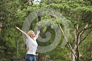 Young happy woman with backpack raising hand enjoy with nature. Woman travel
