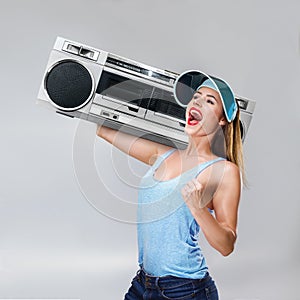 Young happy woman with boombox