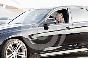 Young happy woman bought new modern car.