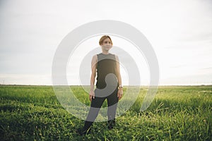 Portrait of beautiful asian woman smiling and looking away at grass field.