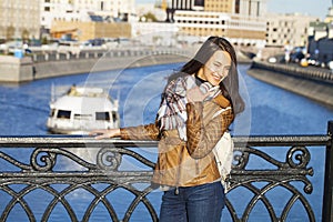 Young happy woman in brown leather jacket