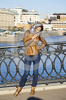 Young happy woman in brown leather jacket