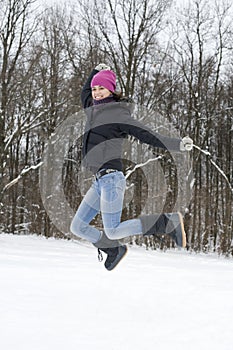 The young happy woman the brunette jumps on snow