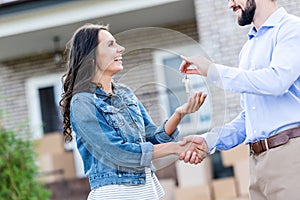young happy woman buying new house and taking keys