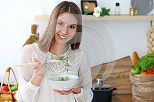 Young happy woman cooking in the kitchen. Healthy meal, lifestyle and culinary concepts. Good morning begins with fresh