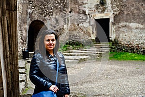 Young happy woman at Corvin Castle, Romania