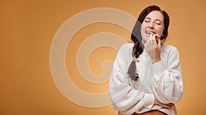 Young happy woman eating freshly baked gingerbread cookie.