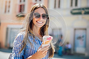 Young happy woman eating ice-cream, outdoor