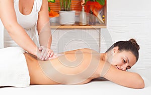 Young happy woman enjoying the massage