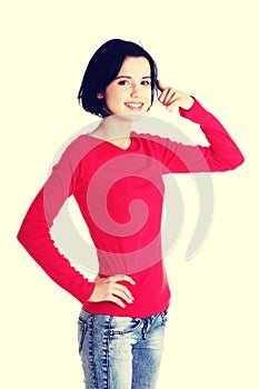 Young happy woman gesturing call me