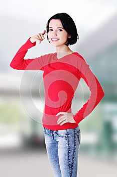 Young happy woman gesturing call me