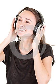 Young happy woman with headphones looks up left