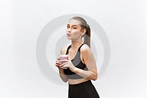 Young happy woman with healthy diet shake drinking for sport and fitness.