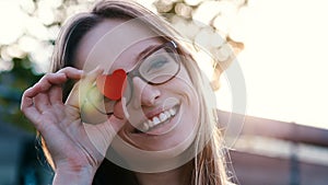 Young happy woman holding heart shape over her glasses. Copy space. Romance