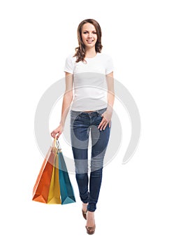 A young and happy woman holding shopping bags