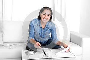 Young happy woman at home couch accounting bank and business papers