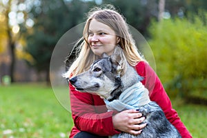 Young happy woman hugging dog. pet adoption.