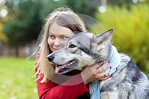 Young happy woman hugging dog. pet adoption. czechoslovak with female owner.